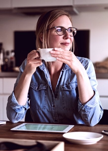professional woman enjoying coffee with tablet