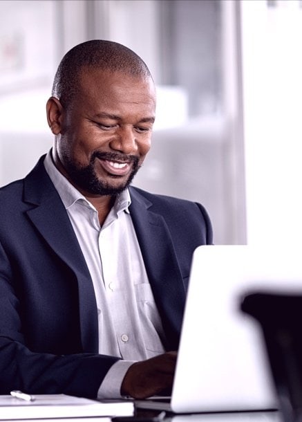 professional man smiling using computer