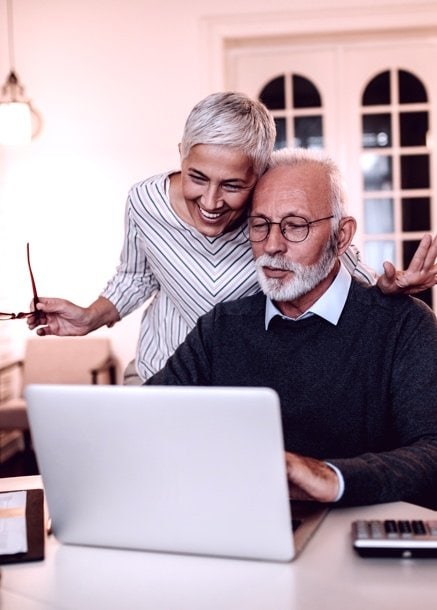 older couple excitedly using computer