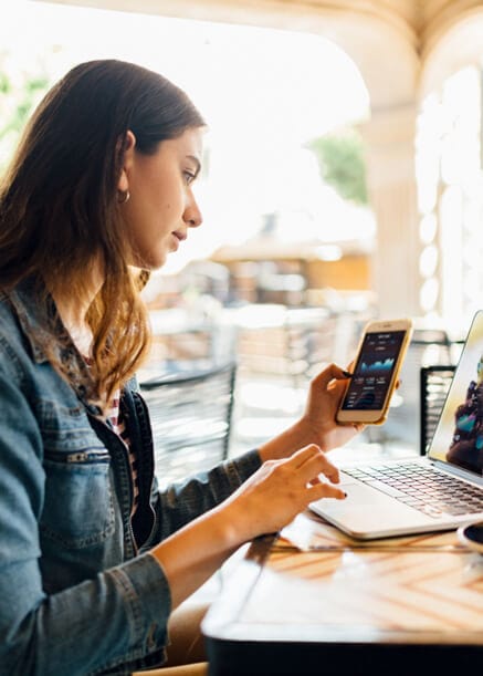 woman checking out cryptocurrency charts on phone